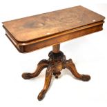 A Victorian fold-over walnut card/occasional table on baluster and tripartite support.