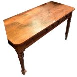 An early 20th century rectangular topped schoolroom writing table, top with ink marks and graffiti,