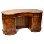 A Georgian-style century crossbanded walnut and mahogany kidney-shaped desk comprising one long and