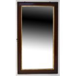 A large oak-framed bevel-edged wall mirror, overall 141 x 77cm.