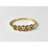 A 9ct gold ring set with five diamonds.