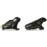 Two Inuit soapstone carvings of walrus, one with carved striations for whiskers,