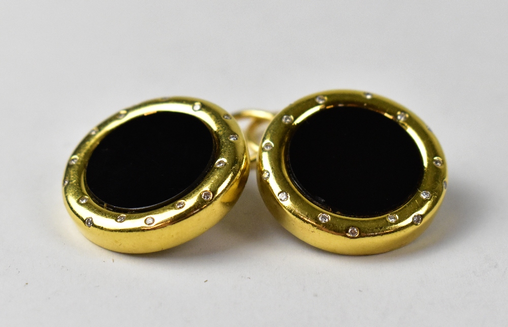 A pair of 18ct yellow gold clip-on earrings with black onyx centre and set with seventeen small