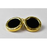 A pair of 18ct yellow gold clip-on earrings with black onyx centre and set with seventeen small