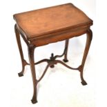 A late 19th/early 20th century rosewood card table with twist and fold-over top enclosing green