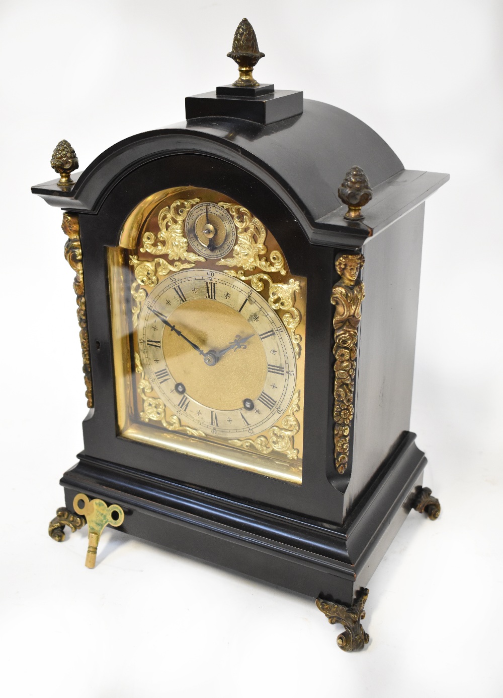 An early 20th century eight day bracket clock in ebonised and ormolu case with pineapple finials to
