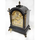 An early 20th century eight day bracket clock in ebonised and ormolu case with pineapple finials to