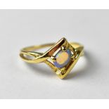 A 14ct gold crossover ring set with opal, approx 2.2g.