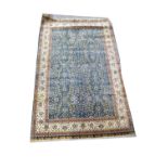 A large modern good quality handmade Turkish rug with centred rectangle floral pattern on blue