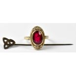 A 9ct yellow gold ladies' dress ring set with oval faceted red stone, tests as ruby,