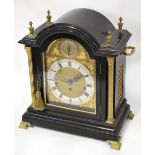 A good and large late 19th century ebonised bracket clock, the arched mouldings with brass finials,