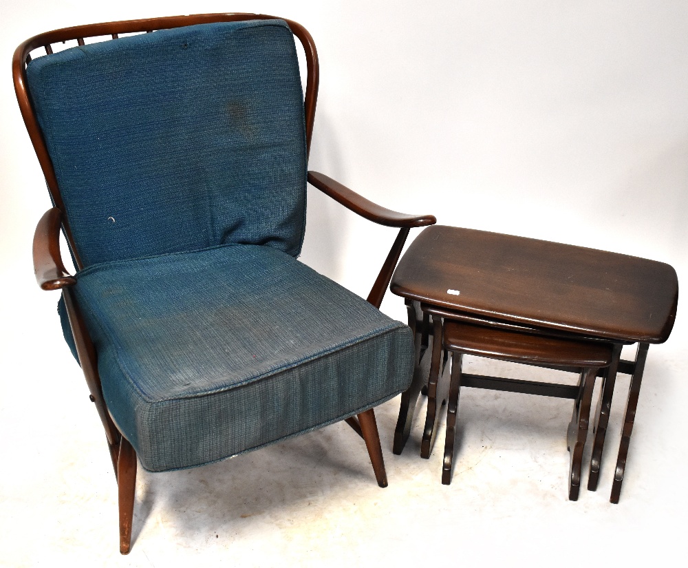 ERCOL; a set of three oak tables and an Ercol oak armchair,