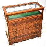 A modern reproduction mahogany bijouterie display cabinet with hinged glazed top and glazed sides,