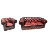 A three-seat Chesterfield settee, button back and upholstered in oxblood leather, width 209cm,