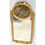A 19th century gilt framed wall mirror with ribbon decoration above chromolithograph of a courting
