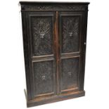 A late 17th century Flemish cabinet, carved scroll top-rail over two twin panel doors,
