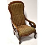 A 19th century spoon back chair with overstuffed seat and outswept and scrolling arms,