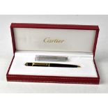 CARTIER; a Mini Diabolo de Cartier twist lock ballpoint pen, with black body,
