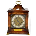 A German walnut veneered mantel clock with brass dial and silvered chapter ring set with Roman