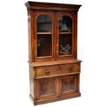 A Victorian flame mahogany bureau bookcase, stepped cornice above arched glazed doors,