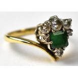 An 18ct gold diamond and emerald ring,