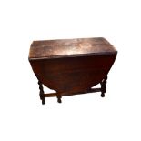 A 19th century drop-leaf gateleg table to wrythen supports, cross-stretcher and ball feet,