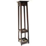 An Arts and Crafts oak hall stand, the top of square form above six hooks,