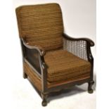 A pair of early 20th century armchairs upholstered in brown and orange moquette,