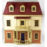 A mid-20th century dolls' house in the form of a three story Georgian style town house with porch