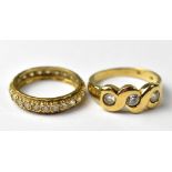 Two 9ct gold fashion rings to include a white stone set eternity ring,