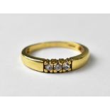 A 9ct gold ring set with three diamonds, approx 2.5g.