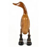 A novelty contemporary carved and wooden polished model of a duck wearing boots, height 45.5cm.