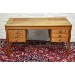 A 1970s teak desk, width 135cm.