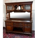 An Arts & Crafts mahogany sideboard, the back section with a small rectangular mirrored plate