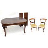 An Edwardian mahogany pull-out extending dining table, together with two additional leaves, raised