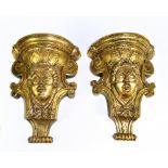 A good and large pair of 19th century carved pine and gilded wall brackets each with female mask