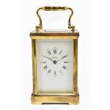 A modern brass carriage clock signed Angelus to the dial, the dial with both Arabic and Roman