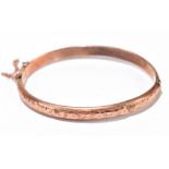 A 9ct rose gold hinged snap bangle, approx 7.5g, (af).Additional InformationSome heavy dents to