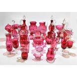 A large collection of Victorian and later cranberry glassware including a Mary Gregory style beaker,