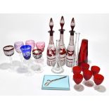 A collection of assorted glassware including three decanters, an assortment of hock glasses, a
