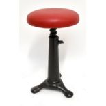 SINGER; an iron framed adjustable machinist's stool, with rising top and later red cushion, height