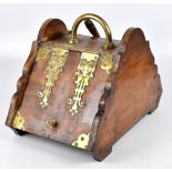 A late Victorian walnut brass mounted coal scuttle of arched form with shovel, width 33cm.