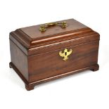 A George III mahogany tea caddy, the hinged cover enclosing three compartments, raised on bracket