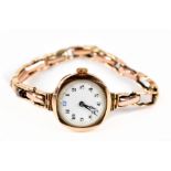 A lady's 9ct gold wristwatch, the white enamel dial with Arabic numerals, with 9ct flexi-link