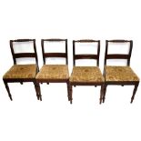 A set of five early 19th century mahogany dining chairs with padded drop-in seats and ring turned