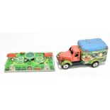 A tin plate clockwork truck, decorated with a pixie and a girl with frogs on a pond, in a