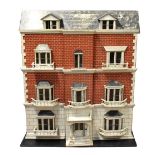 A large German town house dolls' house, the breakfront painted brick façade with seven bay windows