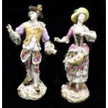 A pair of late 19th century Continental porcelain figures both in elaborate dress with lace trim,