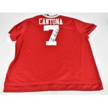 ERIC CANTONA; an Adidas Manchester United 2015 home shirt, signed ‘Eric Cantona’ to reverse, size