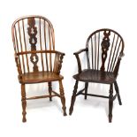 A 19th century elm seated spindle back Windsor armchair, raised on turned column supports, with a